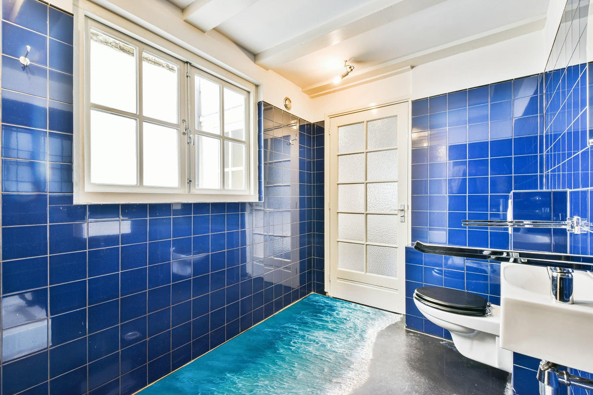 Bright bathroom featuring blue tiles and 3D Ocean Paradise Wall Decal for a beach getaway feel.