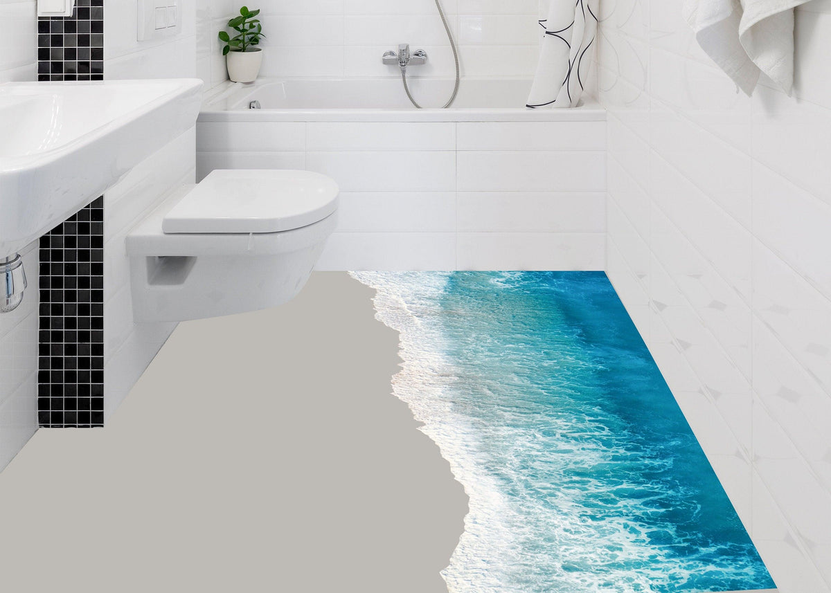 3D ocean beach floor sticker in modern bath setting, transforming space into a serene getaway with stunning water visuals.