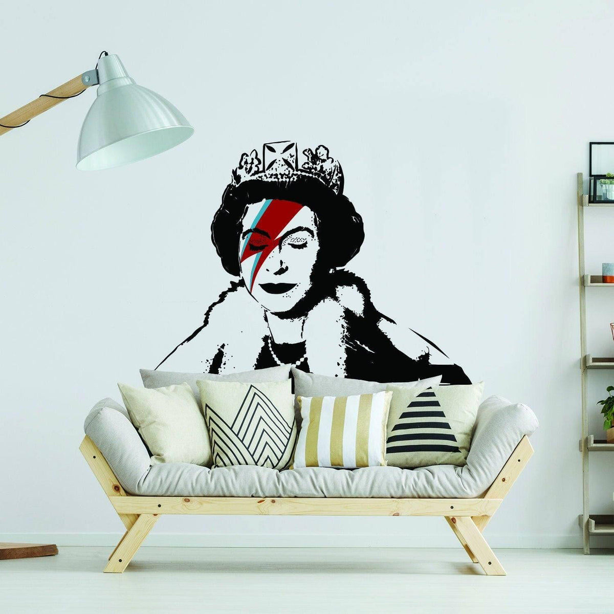 Stylized crowned figure wall sticker with colorful lightning-bolt face paint displayed above a modern couch.