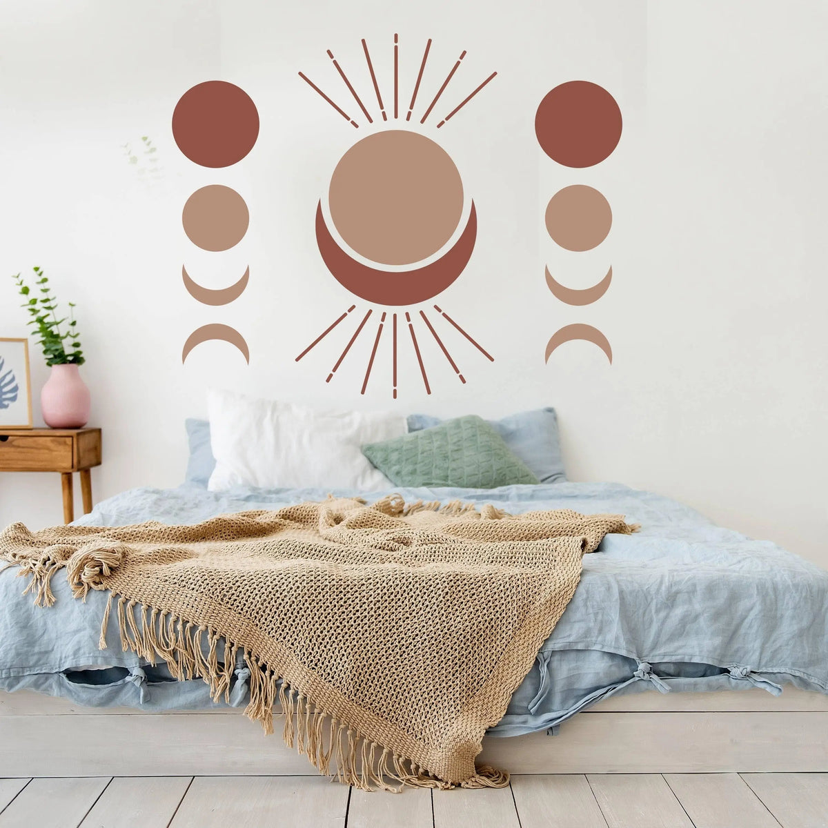 Bohemian crescent and moon phases wall art decal above a cozy bed, enhancing room decor with a boho aesthetic.