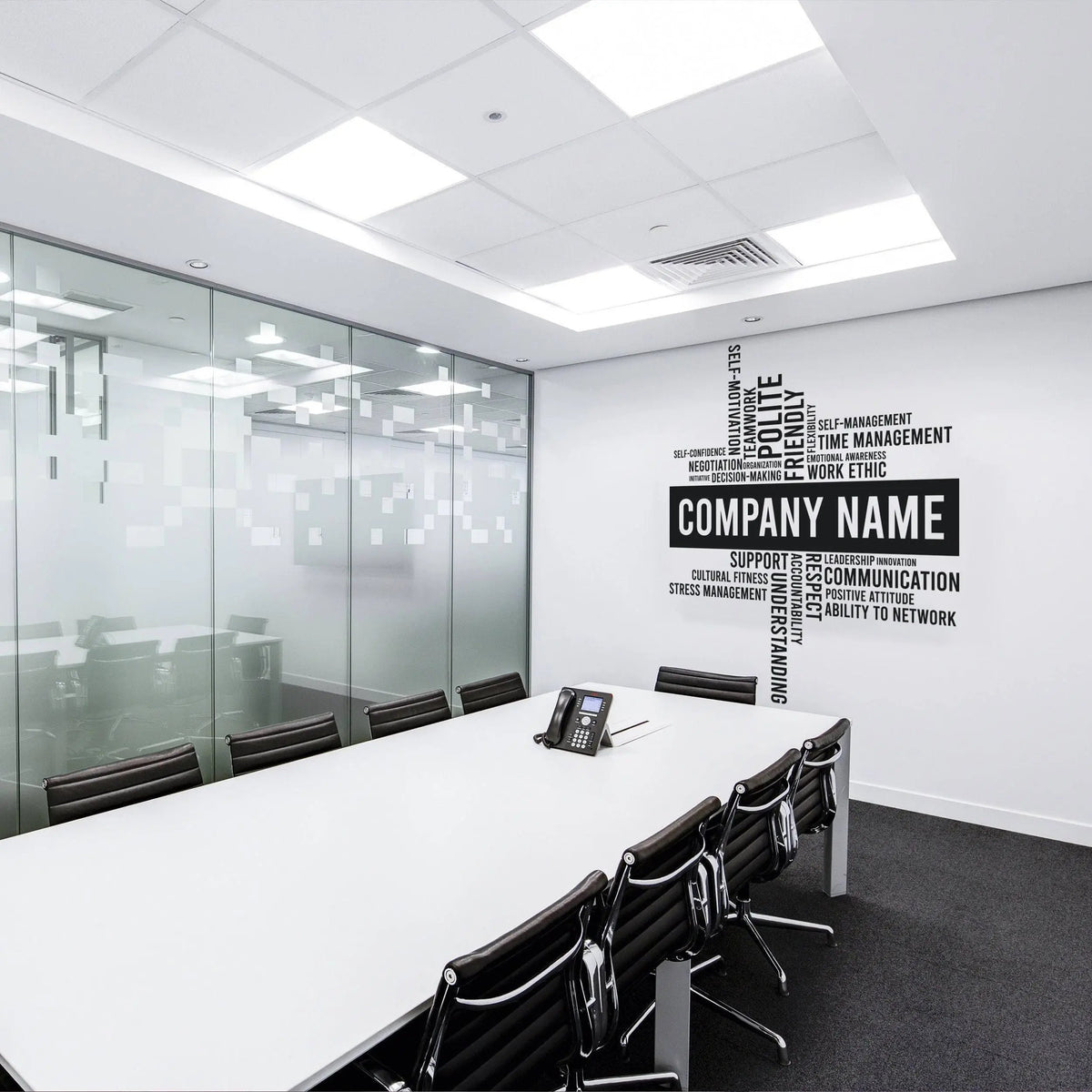 Modern office conference room featuring a personalized wall decal with 'Company Name' and motivational keywords.