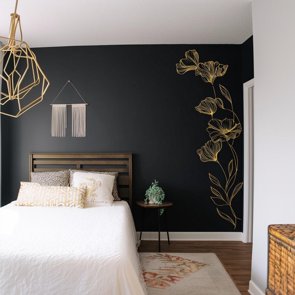 Gold botanical wall decal in a minimalist bedroom, creating an elegant focal point on a dark wall.