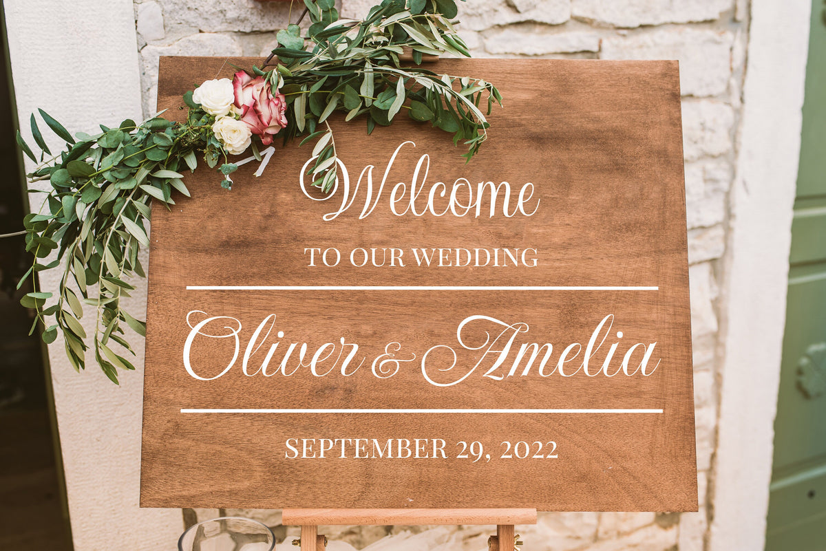 Black personalized wedding sign decal shown in a modern ceremony setting.