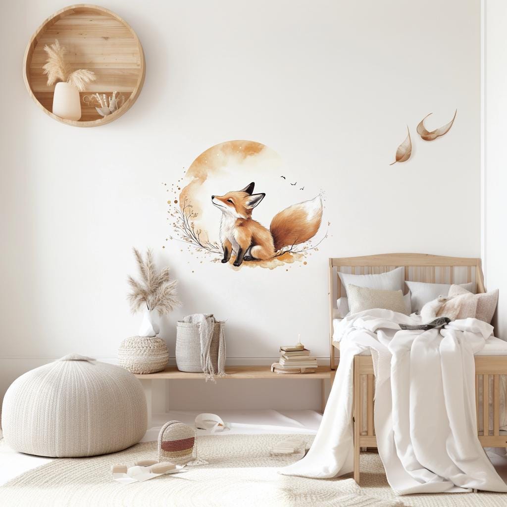 Cute orange fox and golden moon wall decal above a child's bed with cream bedding and wood headboard.