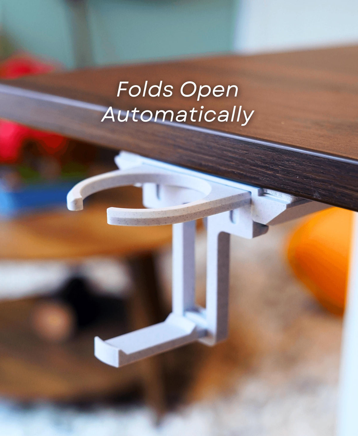 Fold-out under desk cup holder with automatic fold open feature for easy access in a minimal workspace.