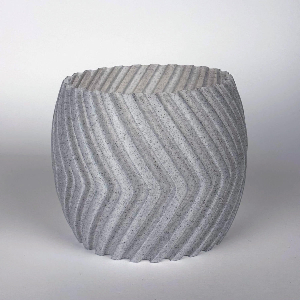 Modern gray zig zag planter cover, stylish 3D-printed decorative pot sleeve for indoor plants.