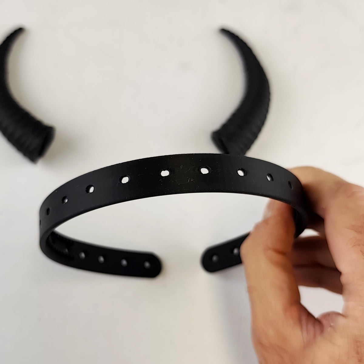 Alternate gallery image of subtle curved demon horns headband highlighting a coordinated pair of textured curved horns mounted on a lightweight band