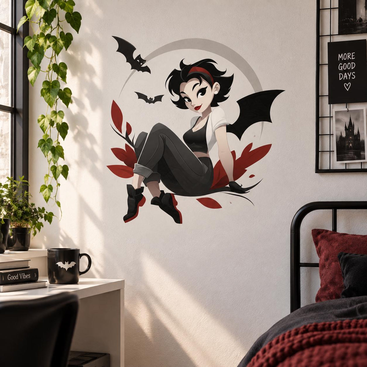 Gothic girl with bat wings wall decal above a dark metal bed and a wooden desk in a bedroom.