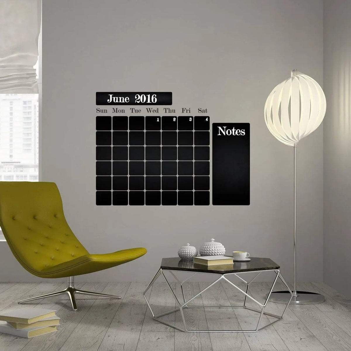 Chalkboard wall sticker with monthly planner design in modern living room setting.