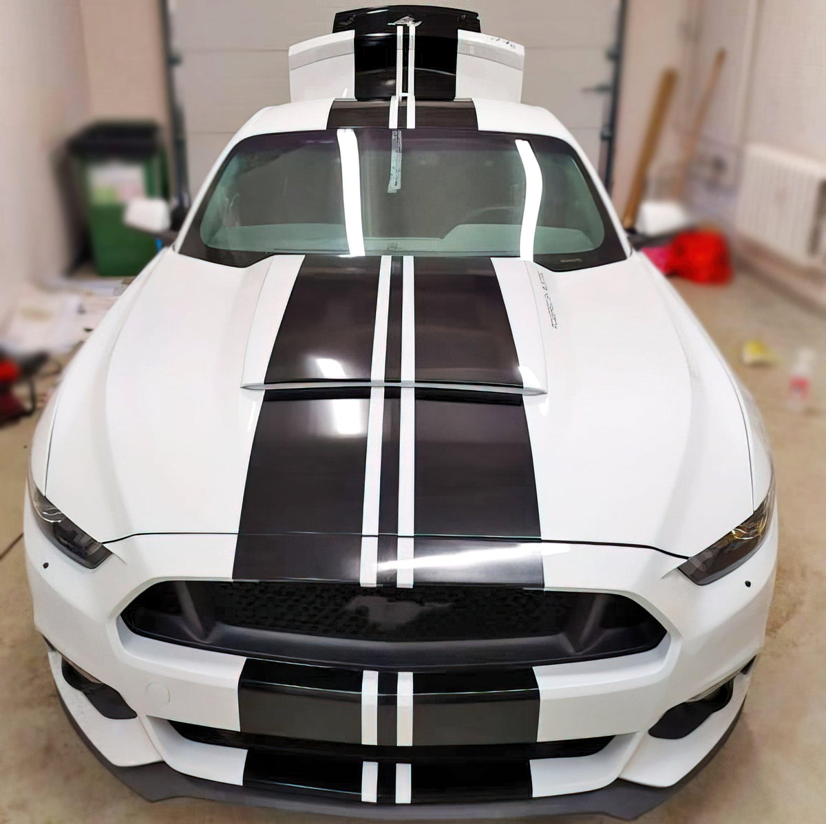 White car with sleek black racing stripes vinyl decals for sporty upgrade.