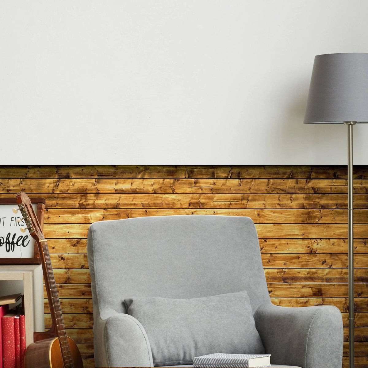 Cozy living room featuring beige chair with rustic wood plank wallpaper and stylish lamp, creating a warm atmosphere.