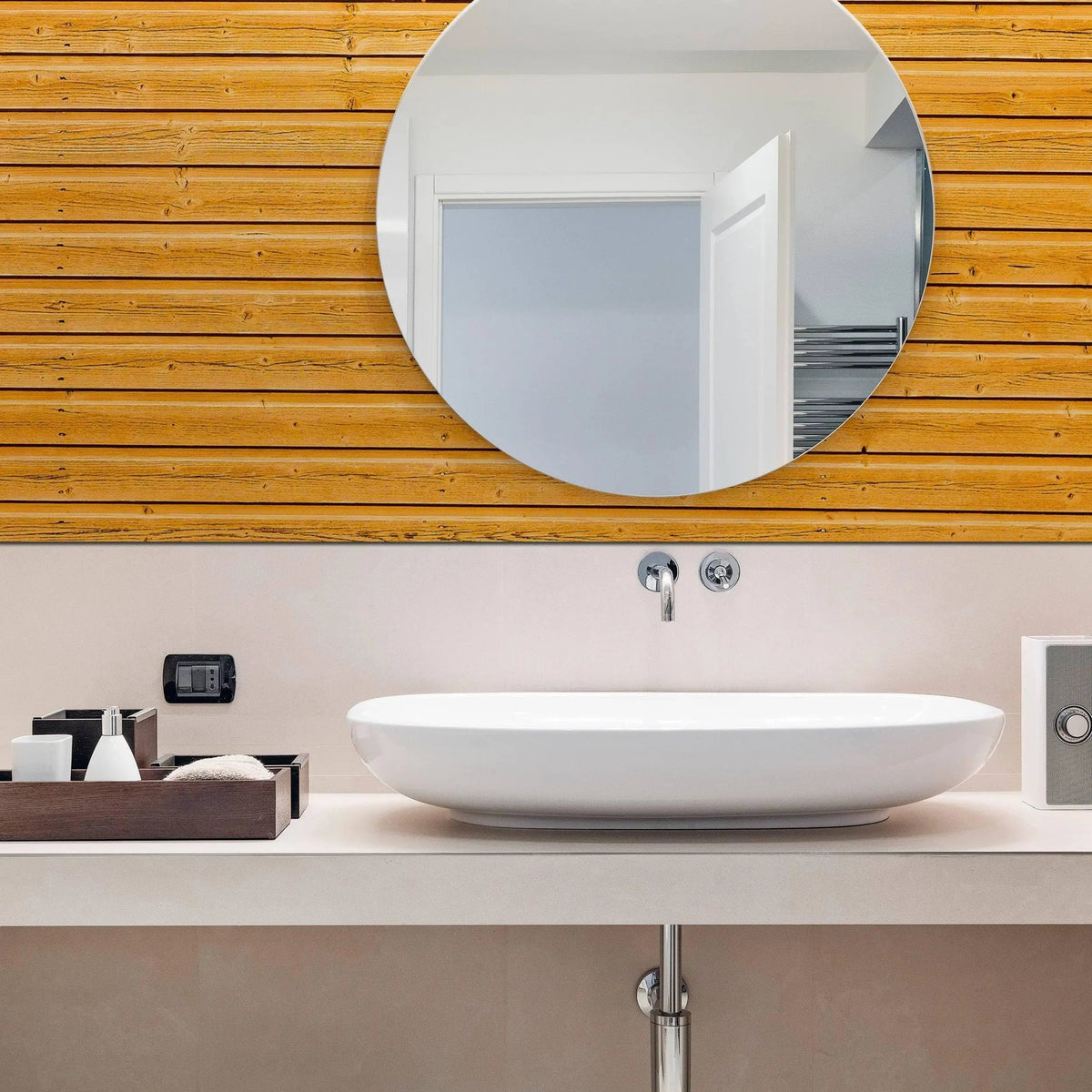 Modern bathroom featuring rustic wood plank peel and stick wallpaper with a round mirror and stylish sink.