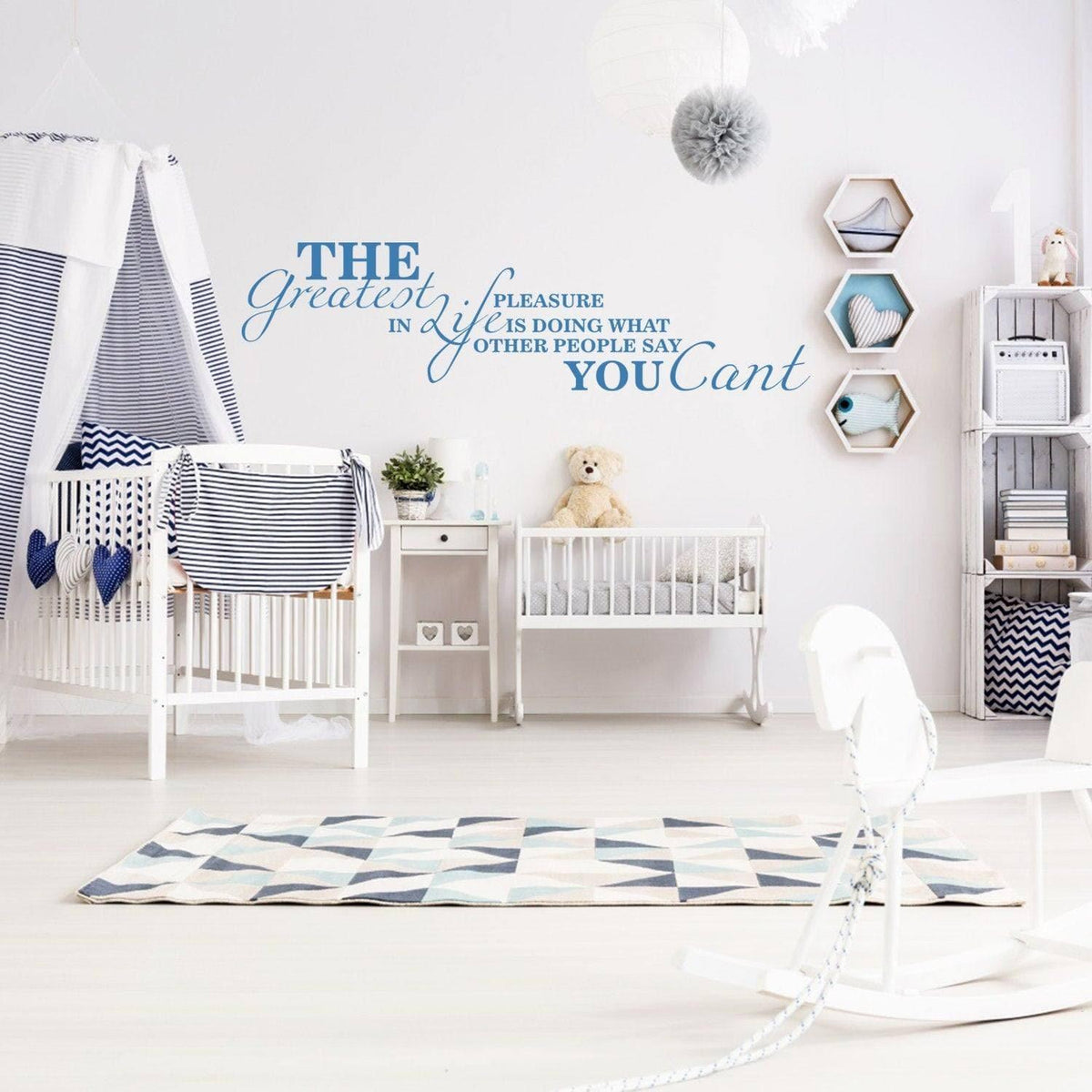 Inspirational wall decal with motivational quote in a stylish nursery with blue and white decor.