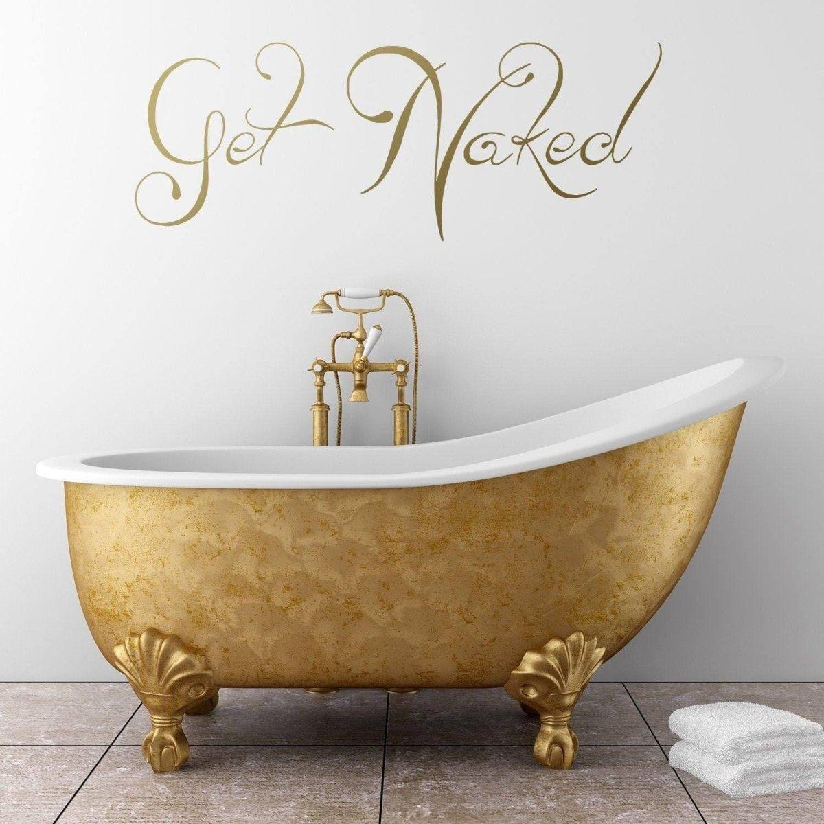 Elegant golden bathtub with 'Get Naked' wall decal, adding humor to bathroom decor.