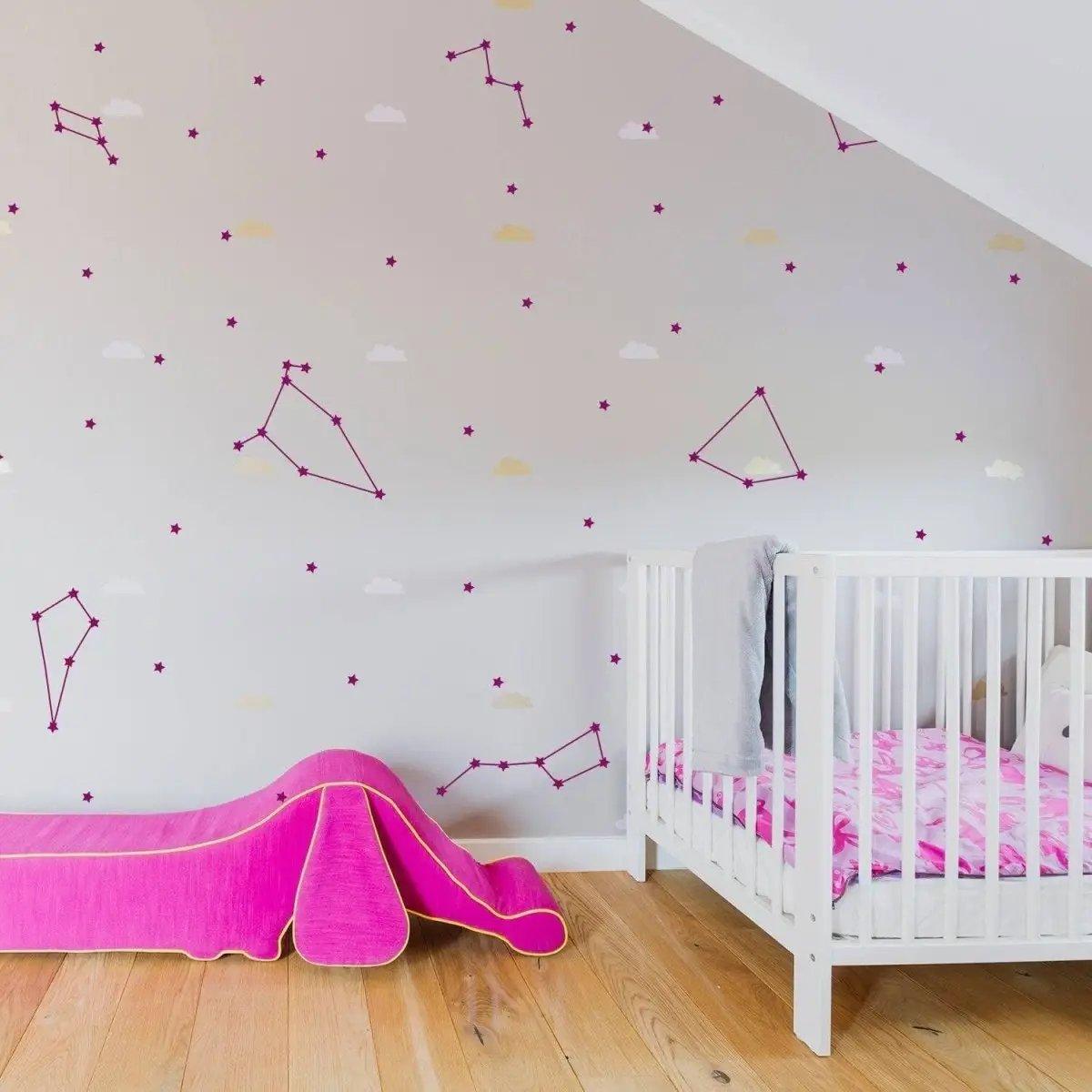 Celestial Dreams themed vinyl wall stickers in a child's room, featuring constellations and clouds on a light wall.