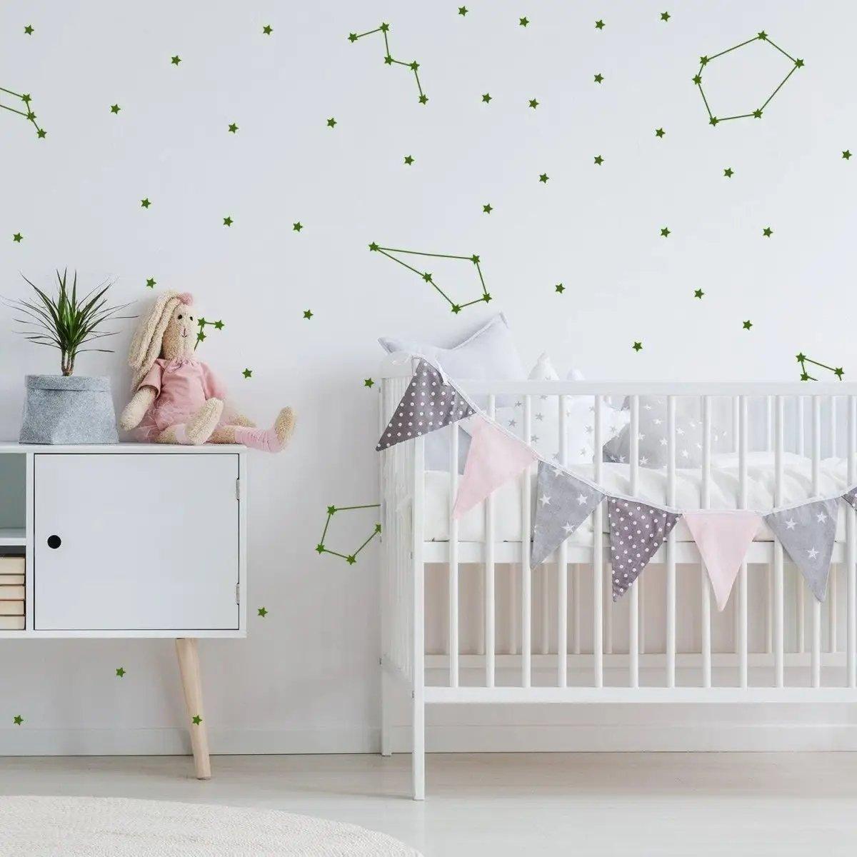 Celestial-themed vinyl wall stickers featuring constellations and stars in a nursery setup with a crib.