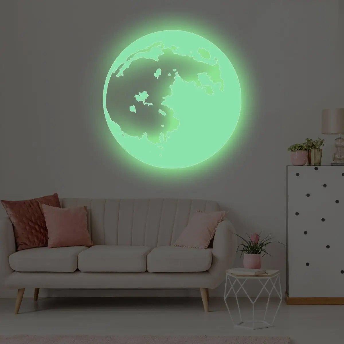 Glow in the dark moon wall sticker set illuminating a stylish living room with cozy sofa and decor.
