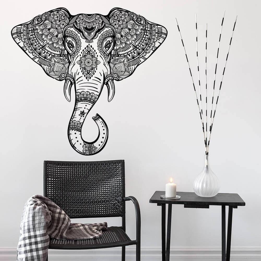 Whimsical elephant wall art decal in stylish design above a modern chair and table, adding charm to any decor.