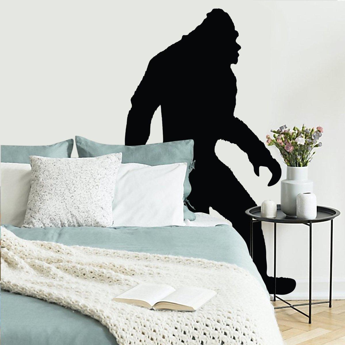 BigFoot vinyl decal sticker on a wall in a cozy living room with decorative pillows and a small table.