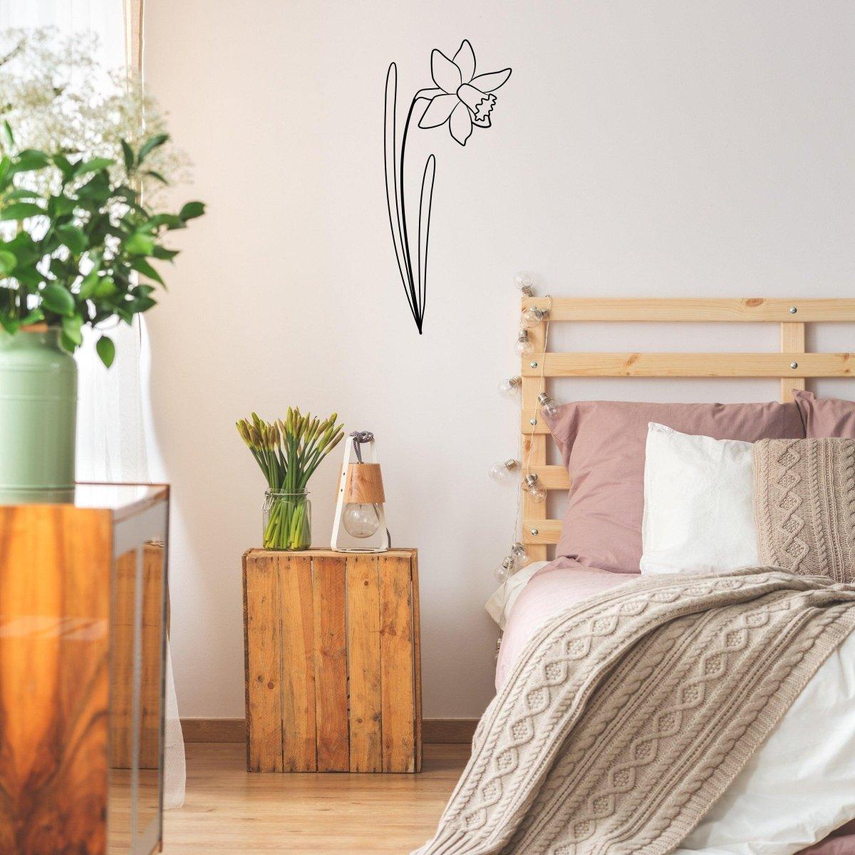 Elegant daffodil wall decal in a cozy bedroom with wood furniture and soft textiles.