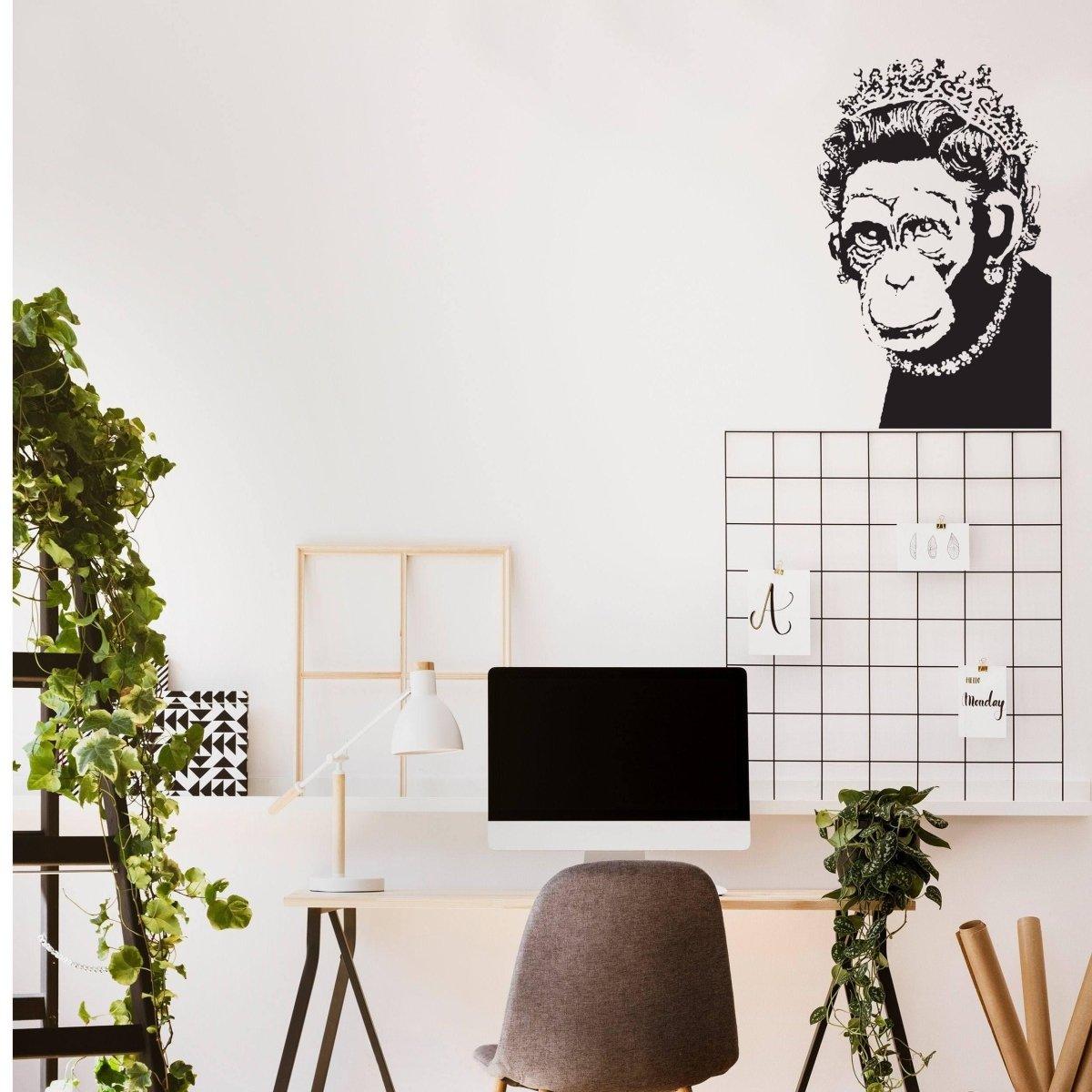 Stylish home office featuring a Queen Monkey vinyl wall art decal above a minimalist desk.