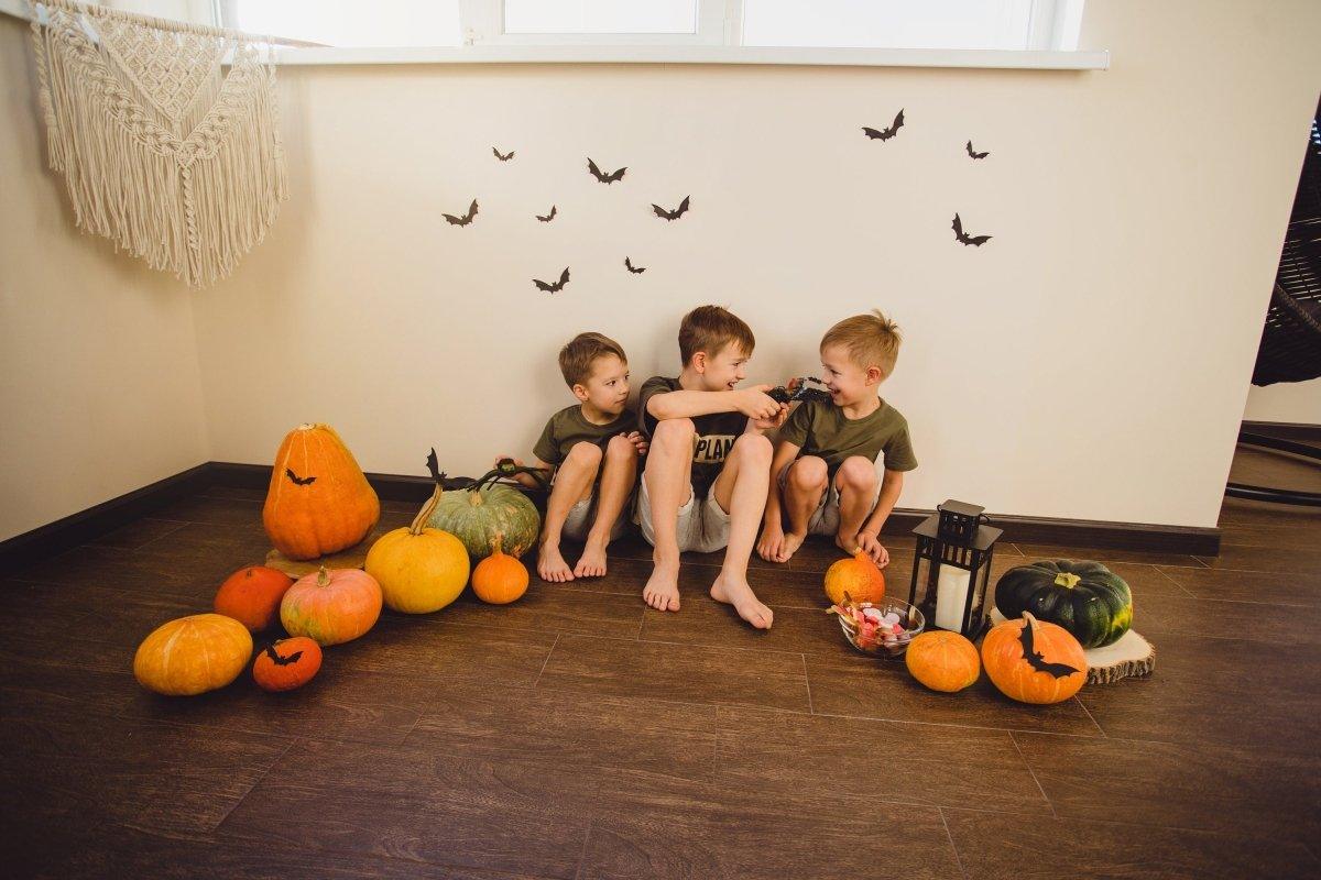 Bat-shaped silhouette decals arranged on a wall above decorative objects.