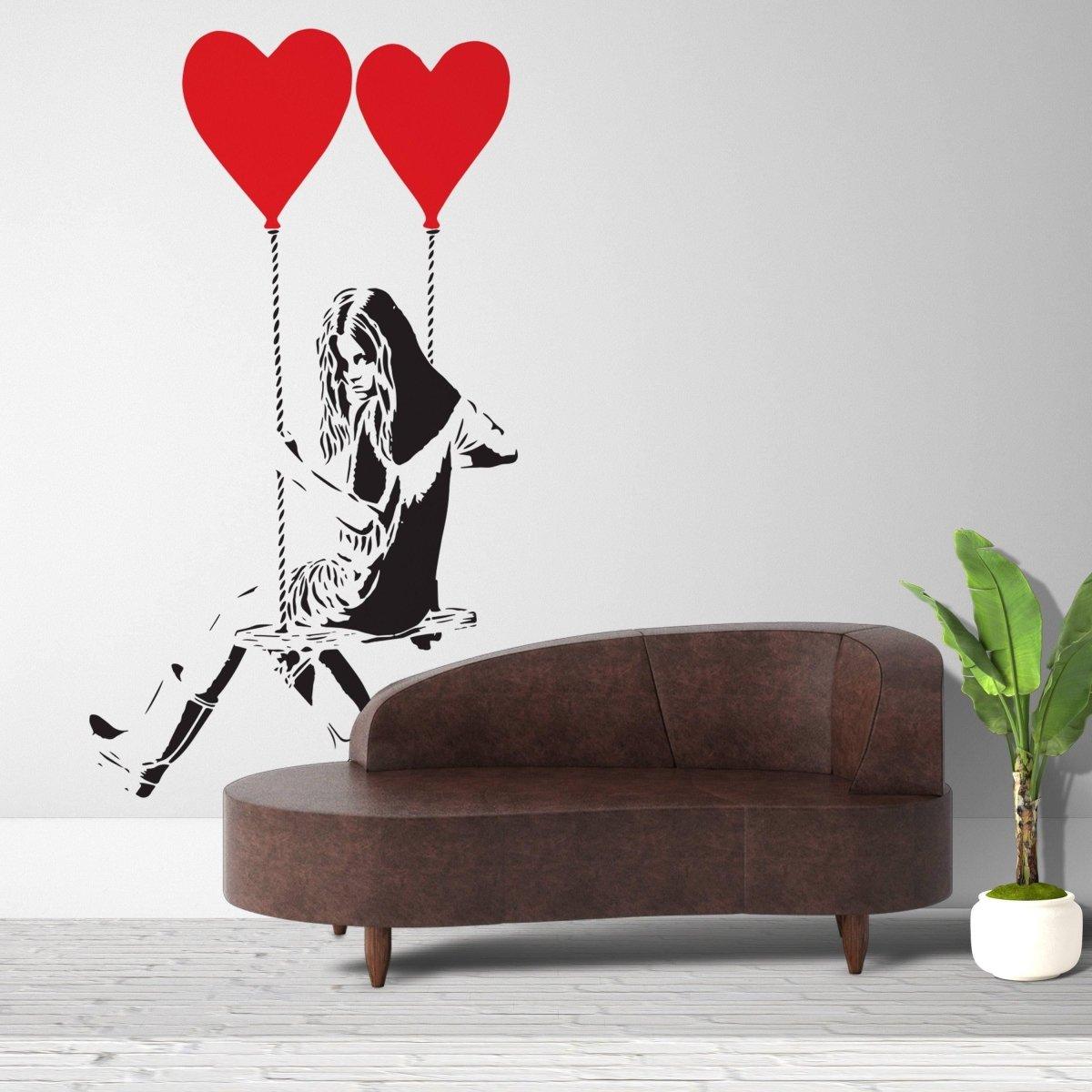 Vinyl heart balloon wall decal of a girl on a swing, adding playful creativity to your interior decor.