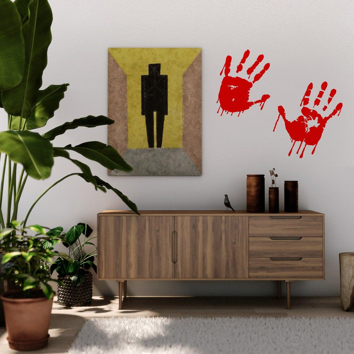 Bloody hands red vinyl sticker on a wall above a wooden furniture with decor.
