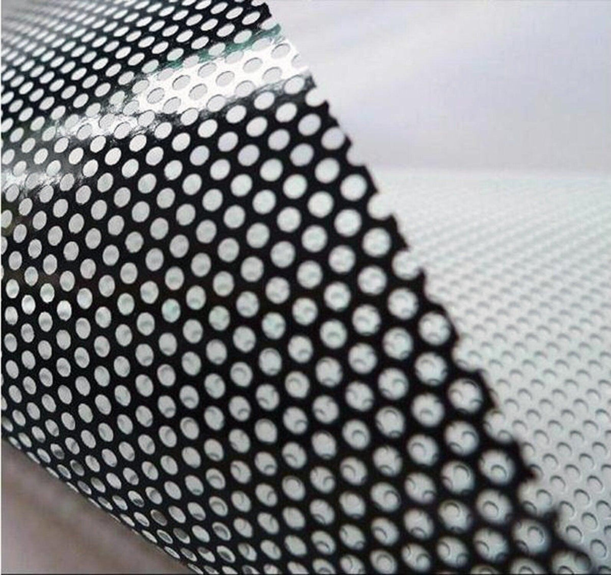 Close-up of custom one way window film showing dot pattern for privacy and light filtration.