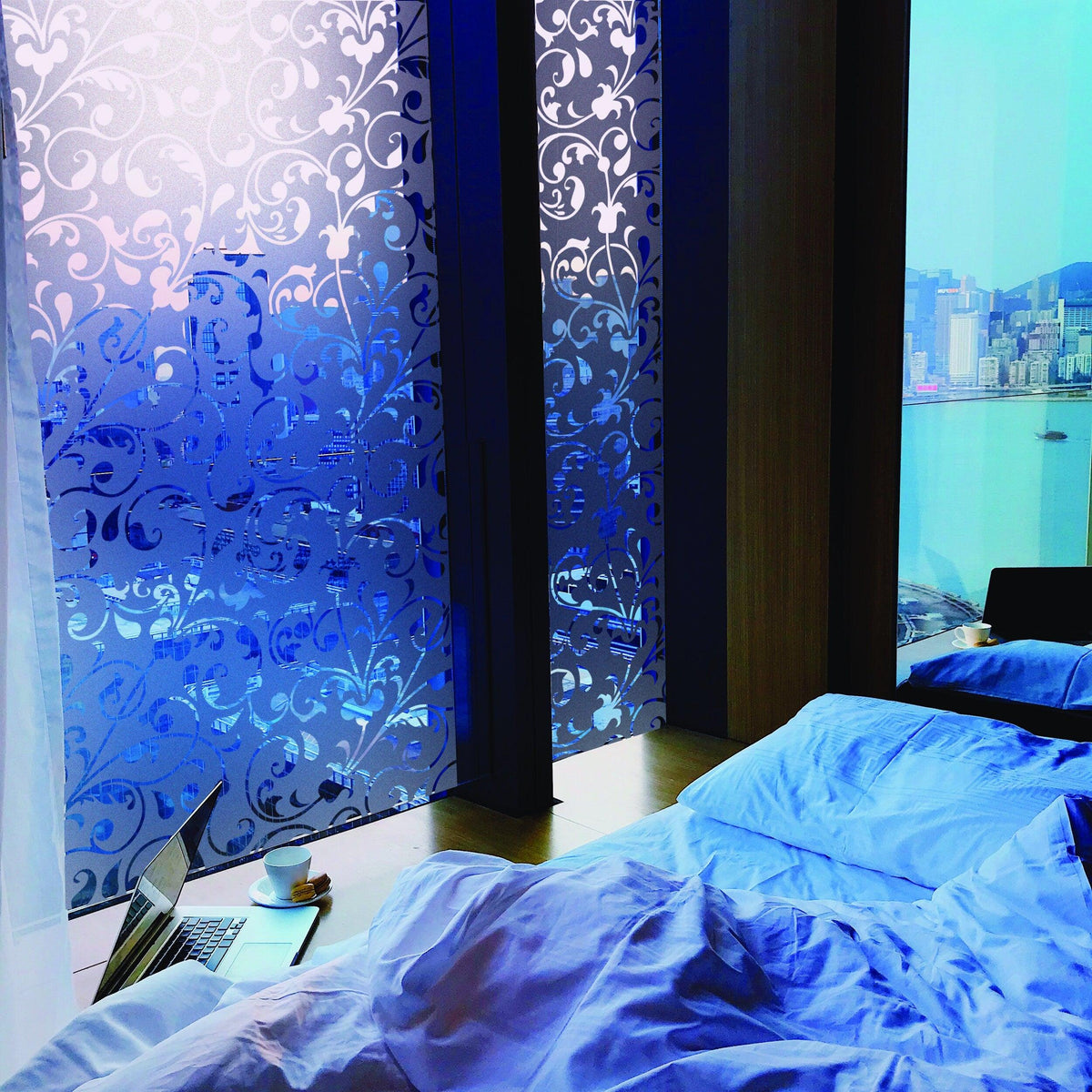 Frosted Film Wow Sticker decal on glass windows in a stylish bedroom with blue tones and minimalistic decor.