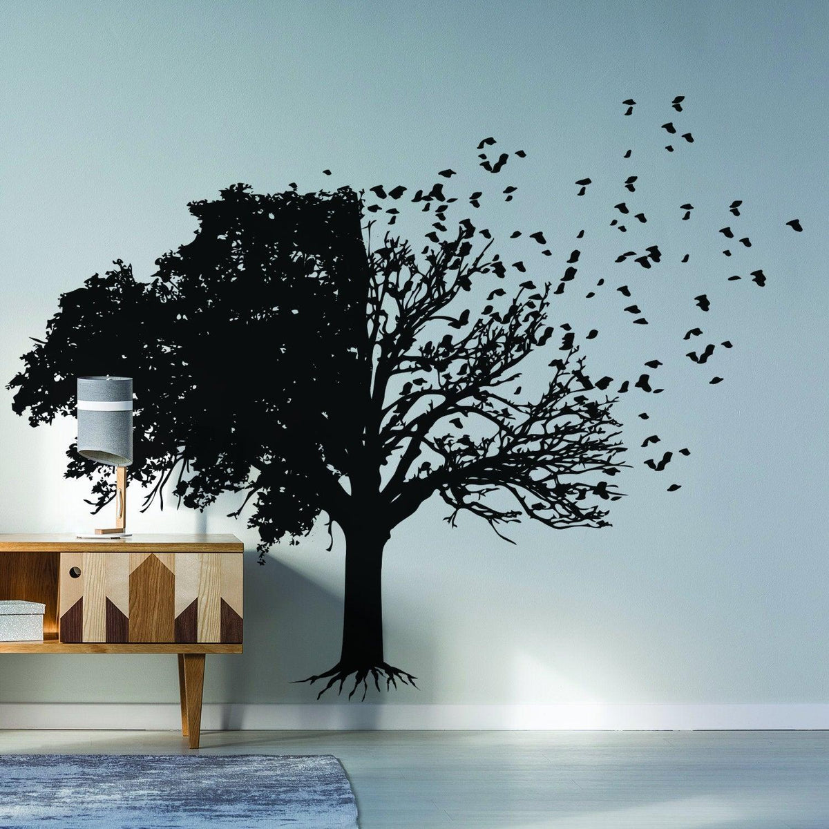 Tree wall decal with birds and branches design on a light-colored wall, enhancing modern living room decor.