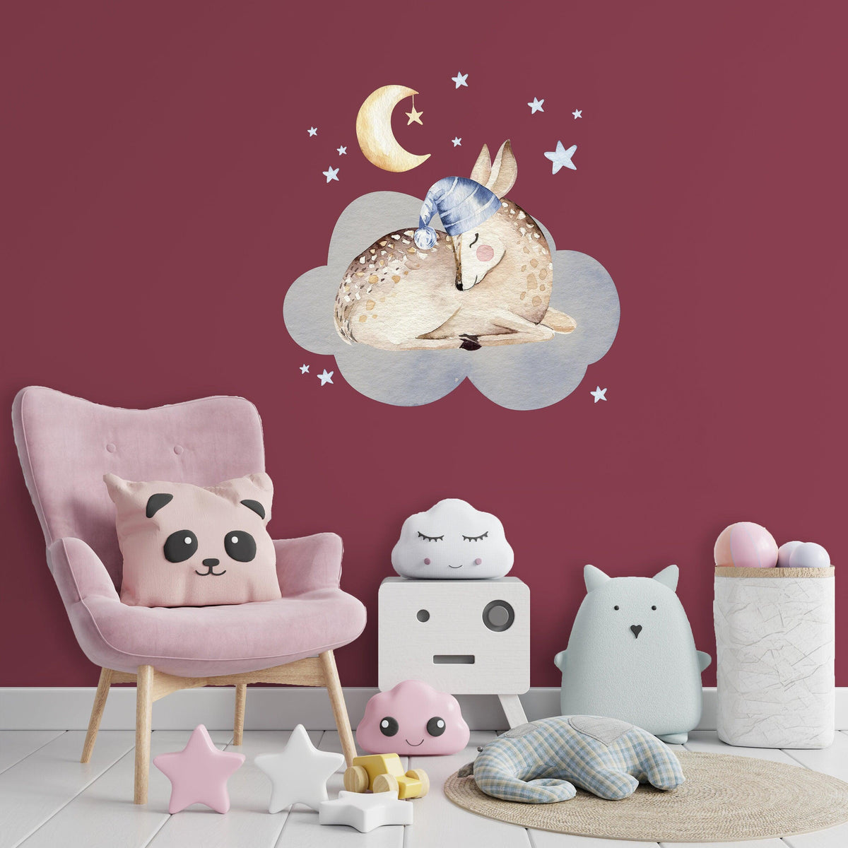Baby nursery wall decor sticker featuring a sleeping deer on a cloud with a crescent moon and stars.