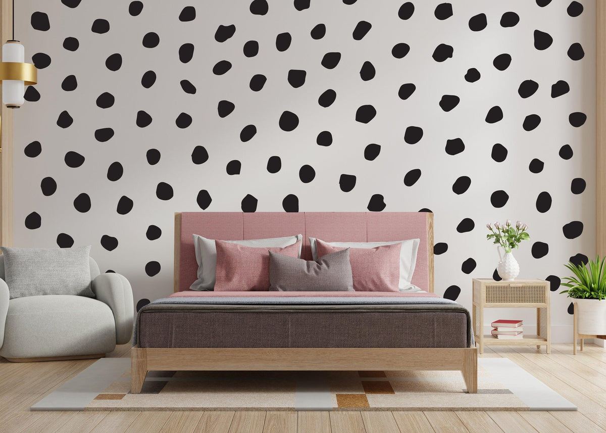 Black polka dot wall decals in a modern bedroom setting, adding playful decor to the room.