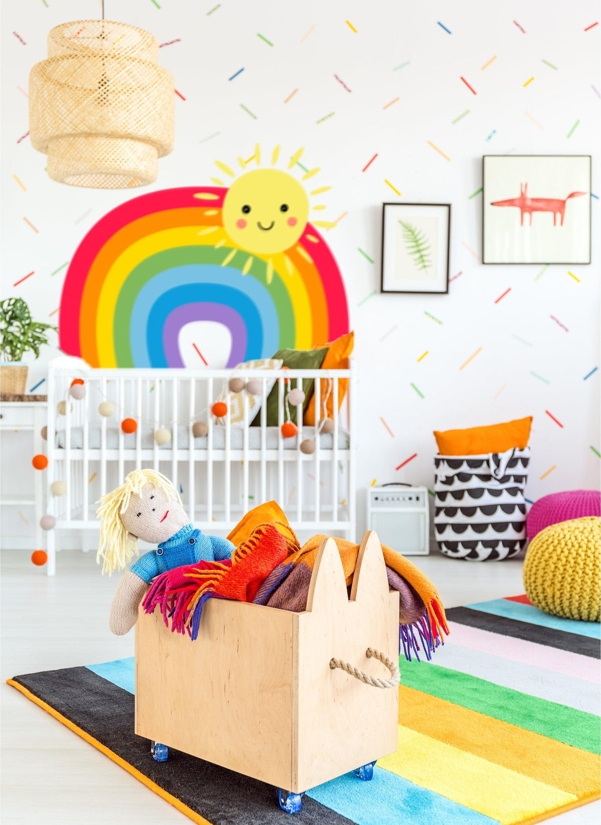 Colorful rainbow wall sticker in a cheerful nursery with toys and playful decor.
