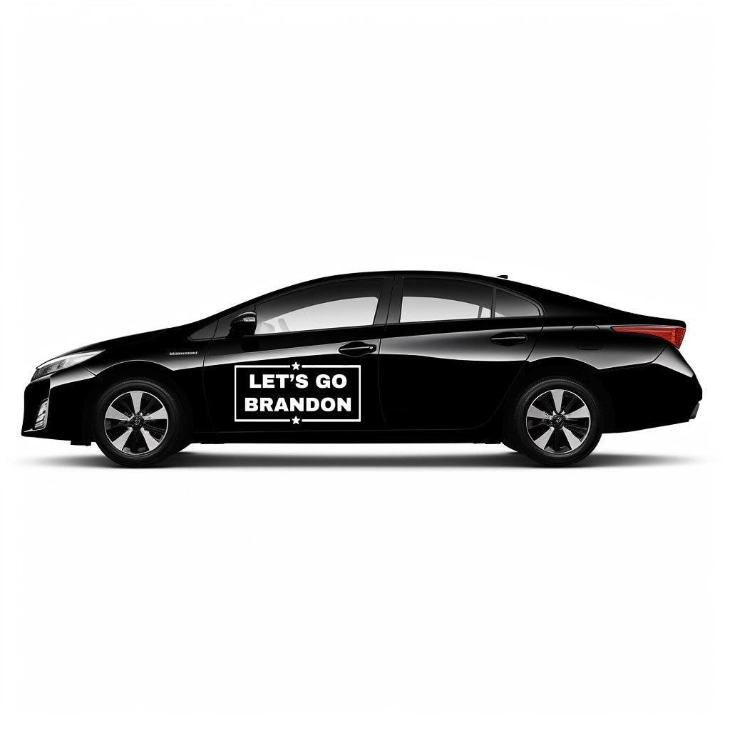 Black car with Let's Go Brandon vinyl decal showcasing political support for Donald Trump.