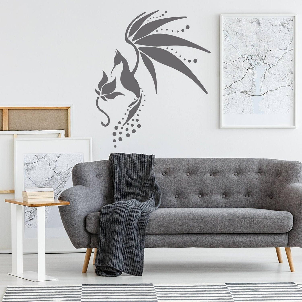Sleek hummingbird wall decal above a stylish gray sofa in a modern living room, enhancing home decor.