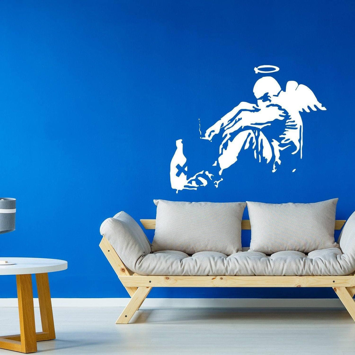 Fallen angel wall sticker displayed on a blue wall in a modern living space.