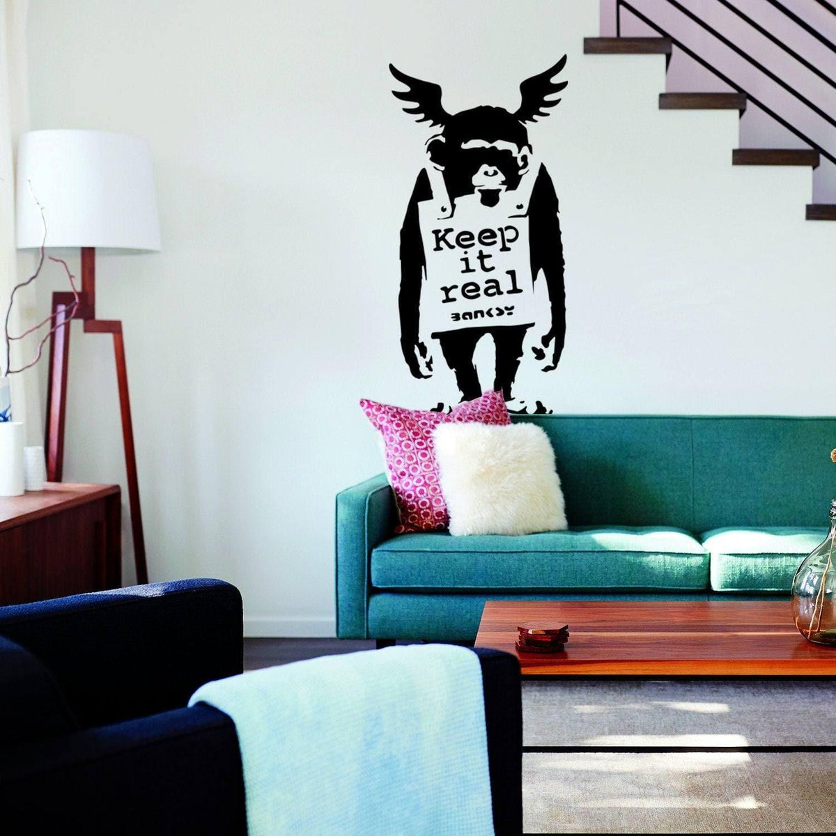 Monkey graffiti wall decal with Keep It Real text displayed in a living room.