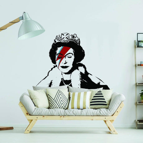 Stylized crowned figure wall sticker with colorful lightning-bolt face paint displayed above a modern couch.