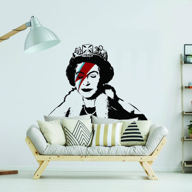 Stylized crowned figure wall sticker with colorful lightning-bolt face paint displayed above a modern couch.