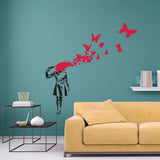 Butterfly Girl vinyl sticker wall decal showcasing a girl with a butterfly explosion above her head in a stylish living room.