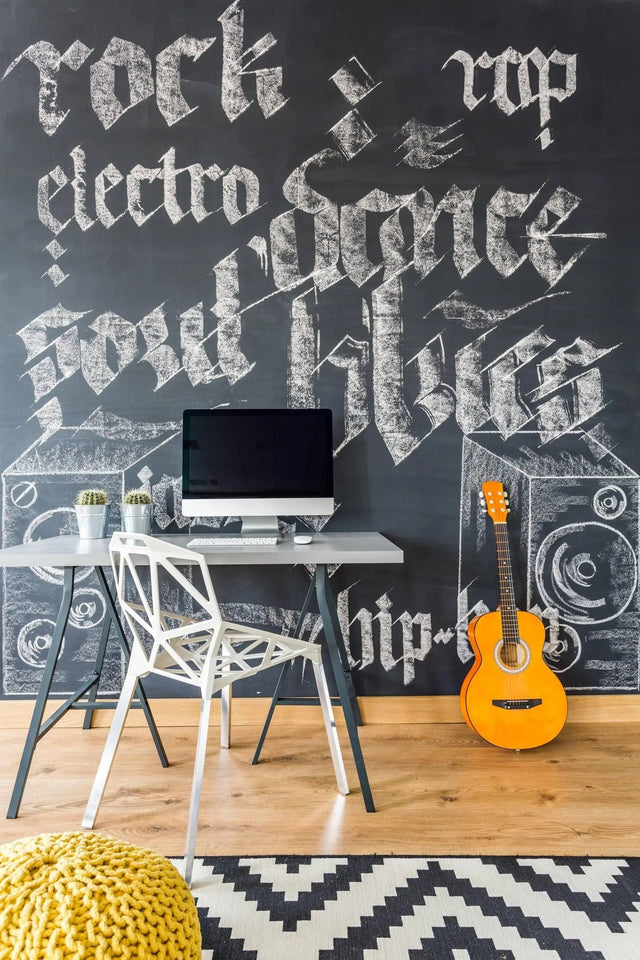 Chalkboard wall decal in a stylish workspace featuring a chair, desk, computer, and guitar for creative inspiration.