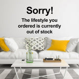 Vinyl wall decal featuring 'Sorry! The lifestyle you ordered is currently out of stock' above a stylish living room couch.