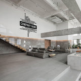 Modern office interior featuring a personalized company name wall decal, stylish furniture, and sleek design elements.