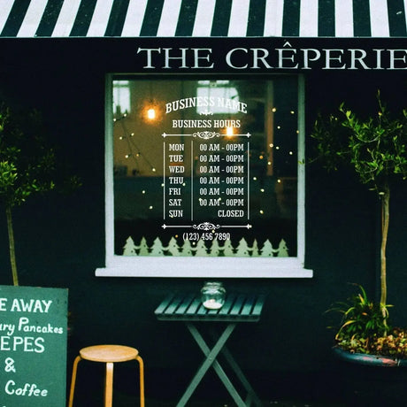 Personalized vinyl business hours decal displayed on a boutique window, showing operating times for a crêperie.
