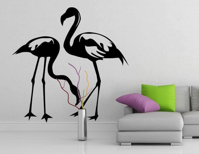 Stylish black flamingo wall decal in modern living room with colorful cushions and decorative vase.