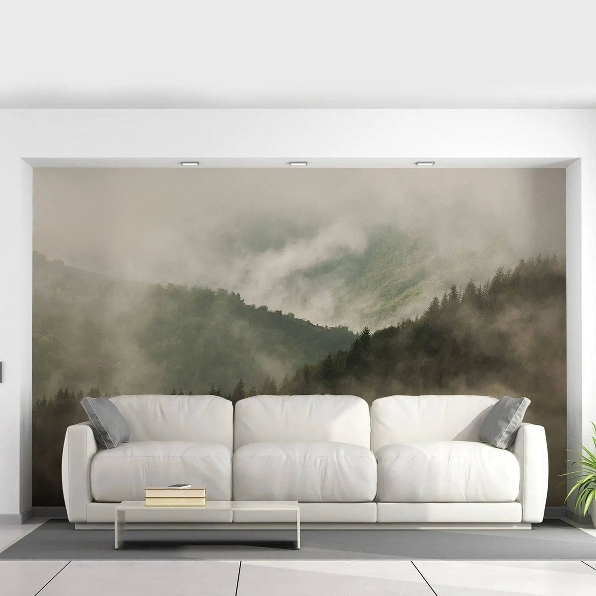 Elegant misty forest landscape wallpaper mural above a modern white sofa in a bright living room.