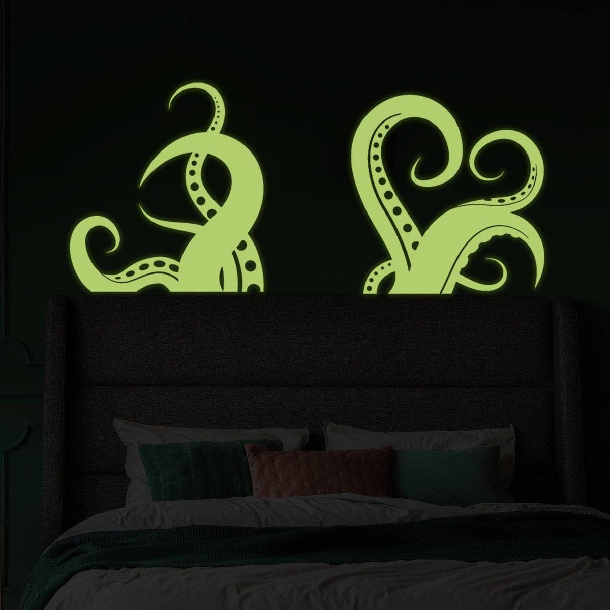 Glowing octopus tentacle wall stickers above bed.