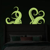Glowing octopus tentacle wall stickers above bed.