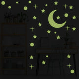 Glow in the dark star and moon ceiling decals creating a starry night effect in a cozy room.